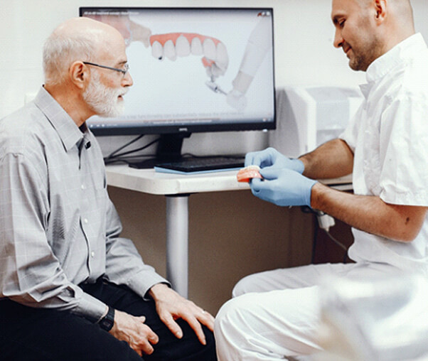 Dentist sharing implant denture process in Carrollton
