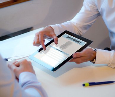 Patient looking at dental insurance form on tablet