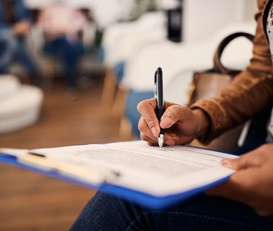 Patient filling out paperwork in lobby