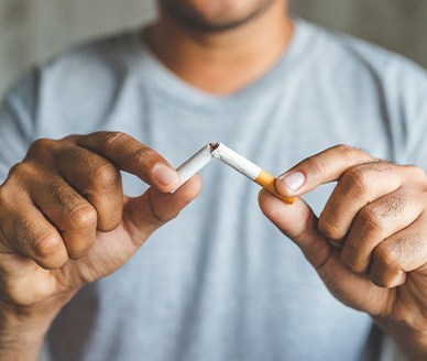 Closeup of patient breaking cigarette