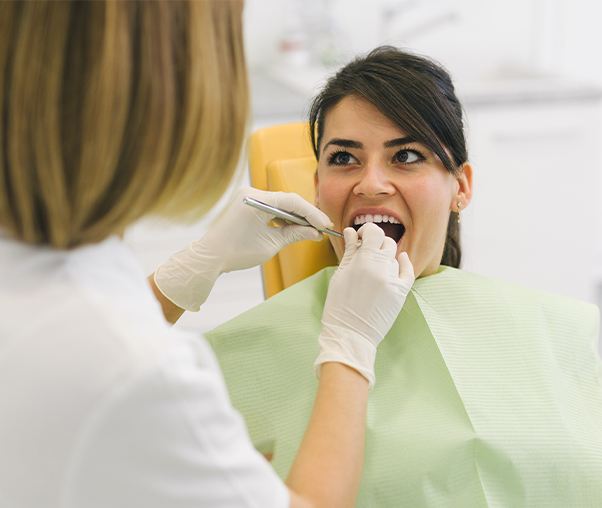 Dentist examining patient's smile