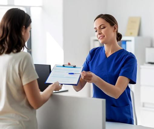Dental team member handing clipboard to patient