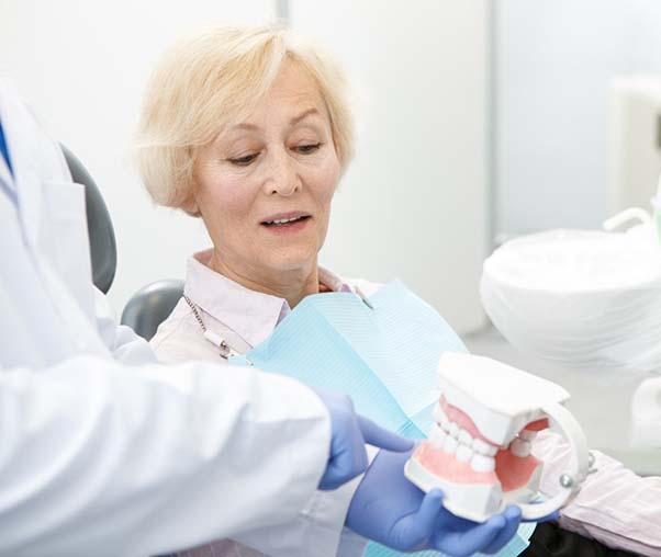 Senior patient’s consultation for All-on-4 dental implant tooth replacement