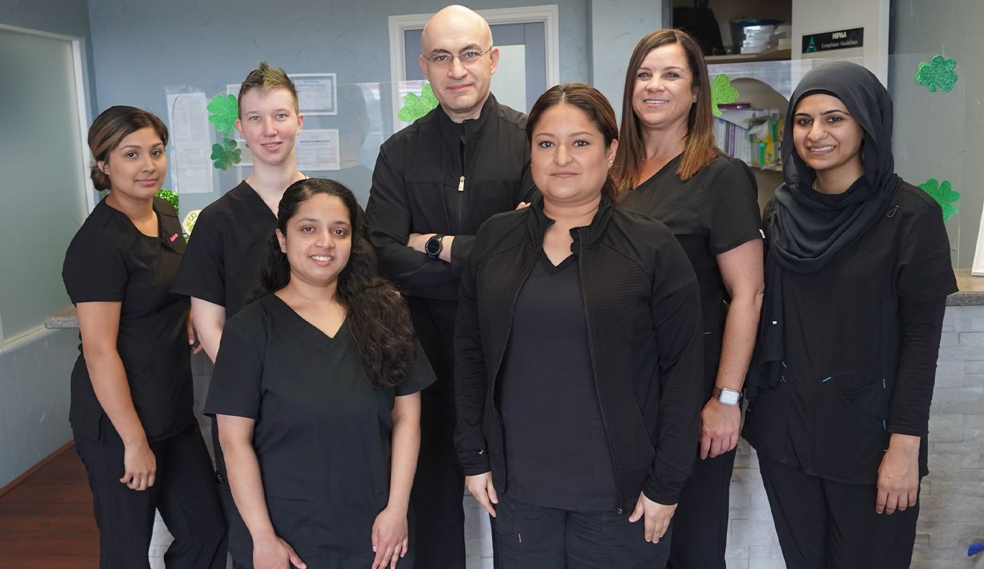 Smiling dentist and team members at Rosemeade Dental in Carrollton Texas