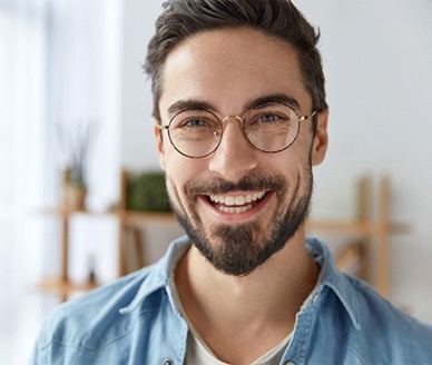 Young man with dental implants in Carrollton 