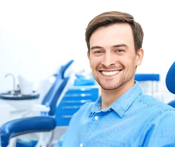 Man smiling with CEREC same-day crowns in Carrollton