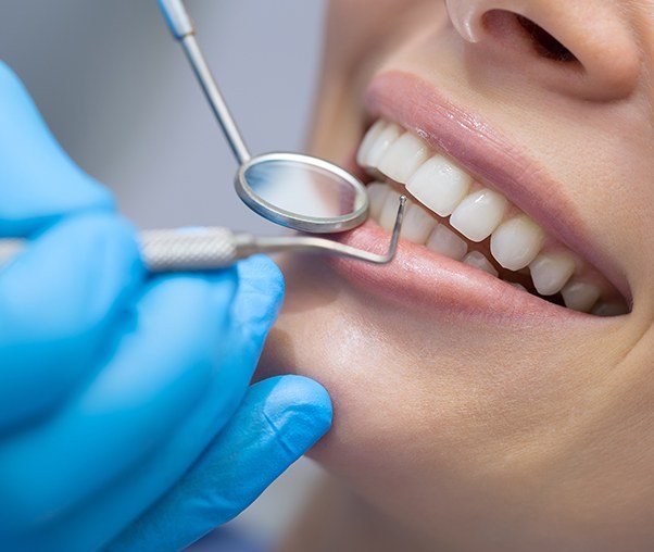 Patient examined by dentist after chao pinhole surgical technique treatment