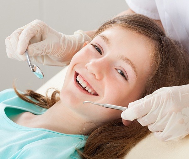 Young girl smiling during children's dentistry checkup