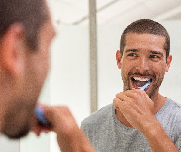 a man brushing his teeth