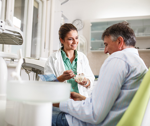 Denture dentist in Carrollton talking to patient about dentures