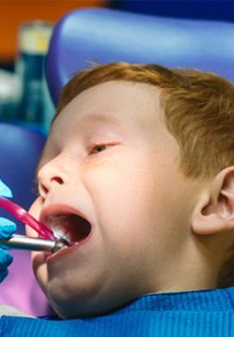 young child getting dental checkup 