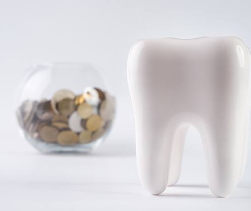 tooth and coins representing cost of root canal in Carrollton