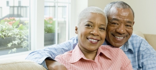 Older man and woman smiling after dental implant tooth replacment