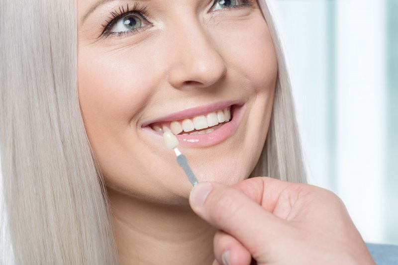 woman smiling while getting veneer color-matched