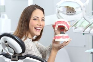 a patient holding their dentures