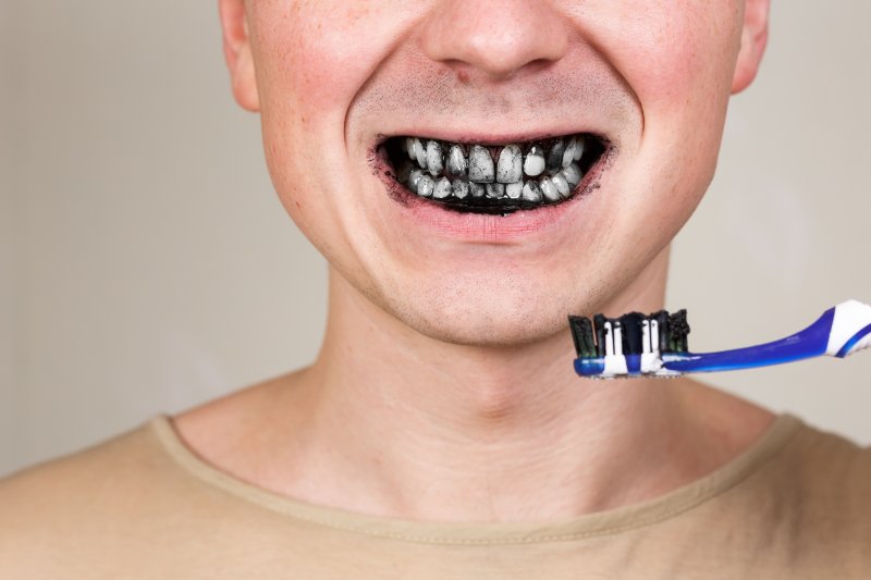 Someone brushing with whitening toothpaste