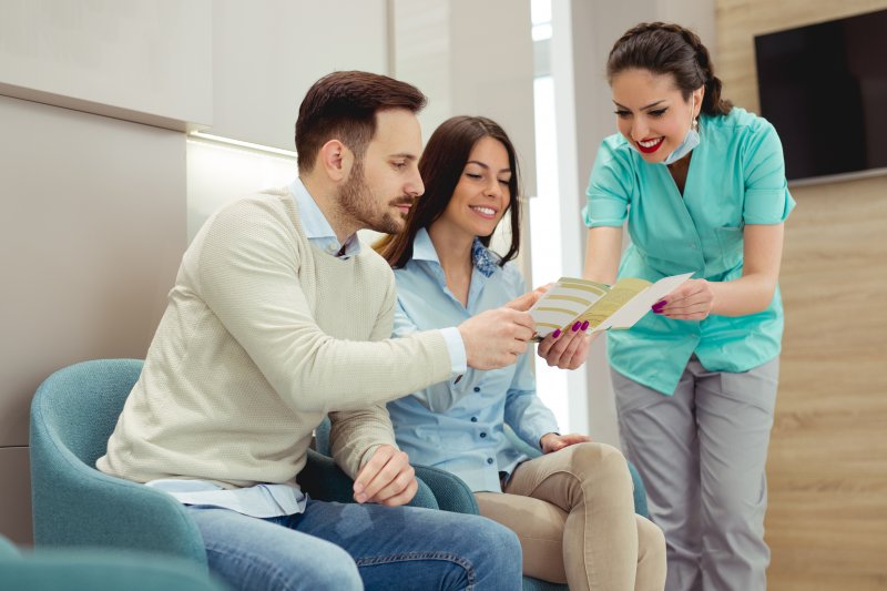 A dentist discussing dental insurance with her patients