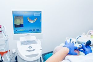 Dentist using intraoral scanner to capture digital impression