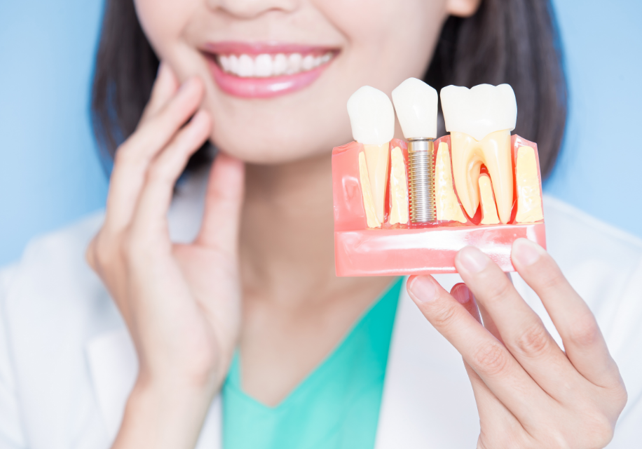 Dentist holding dental implant mold