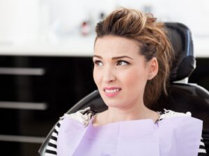 Patient in dentist’s chair looking skeptical.